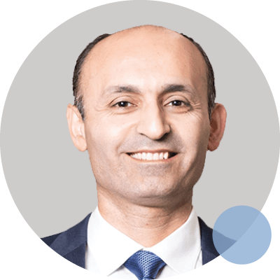 Dr Siamak Seresti smiling in a suit and tie with abstract background elements.