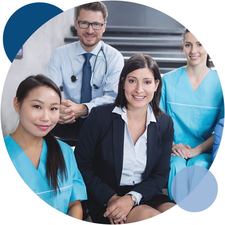 Medical professionals in blue scrubs working together in an occupational health service environment.