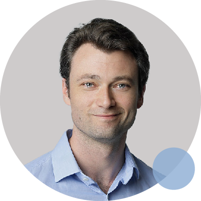 A man in a purple shirt stands beside a blue circle, representing Dr. Sam Young, Orthopaedic Surgeon.