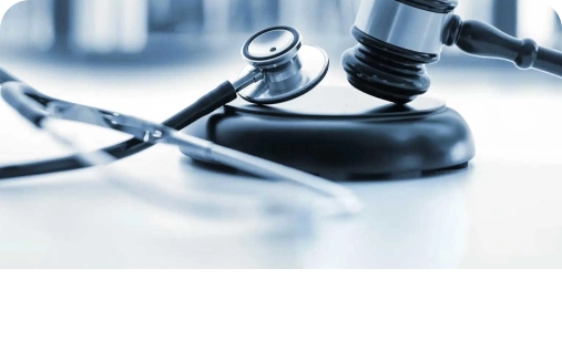 A gavel and stethoscope resting on a table, symbolizing the intersection of law and medicine in medico-legal contexts.