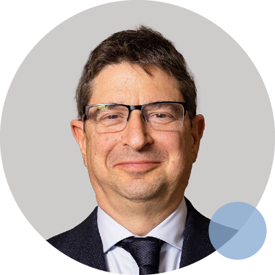 Dr Eli Gabbay smiling in a suit and tie, Respiratory and Lung Disease Specialist at OSHGroup.